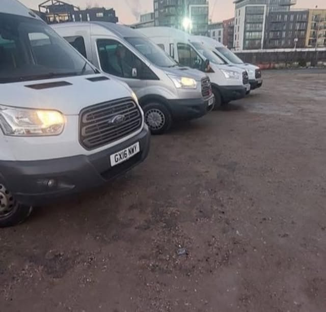 FAMS Ford Transit minibuses lined up on location
